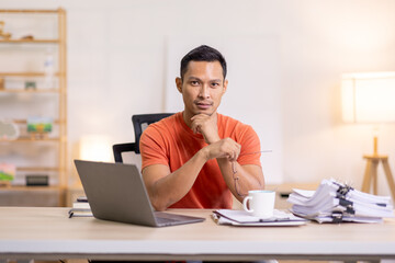 Happy business man work on laptop for email update, online project and reading digital report with mockup space. freelance asian man  entrepreneur and working from home research, planning and info 