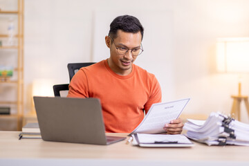 Happy business man work on laptop for email update, online project and reading digital report with mockup space. freelance asian man  entrepreneur and working from home research, planning and info 