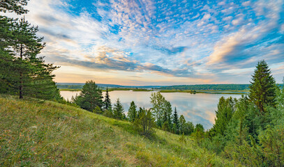 Sunrise on the river bank sun through the trees, beautiful clouds panoramic view. - 659287584