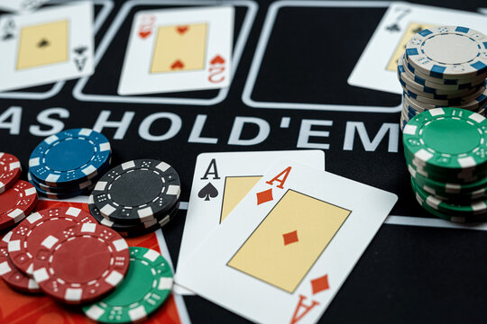 win poker combination cards and stack of chips on black casino table
