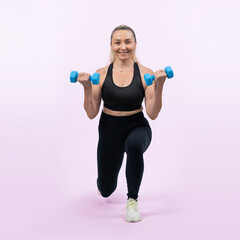 Fototapeta na wymiar Full body length shot active and sporty senior woman lifting dumbbell during weight training workout on isolated background. Healthy active physique and body care lifestyle for pensioner. Clout