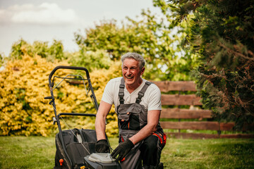 Senior man in business attire demonstrates dedication to his well-kept garden