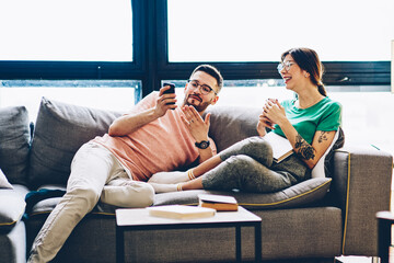 positive couple in love discussing news from comedy website