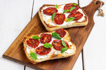 Ciabatta with sun-dried tomatoes, white cheese and basil. Italian food. Vegetarian food.
