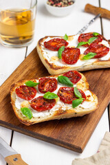 Ciabatta with sun-dried tomatoes, white cheese and basil. Italian food. Vegetarian food.