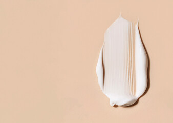 cosmetic smears of creamy texture on a beige background