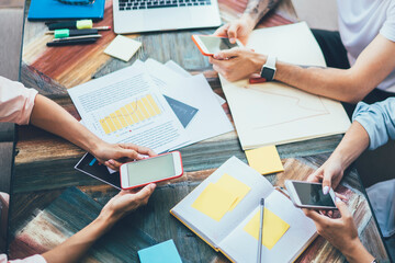 Colleagues planning work on smartphone apps
