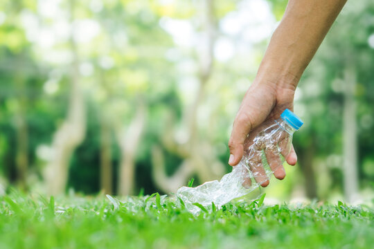 Man hand keep plastic bottle at public park for recycling, reuse, reduce concept.sustainability, environment and package pollution.Ecological waste management and a sustainable.copy space.
