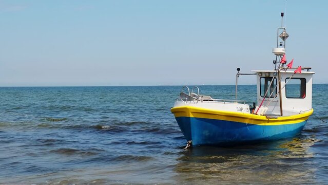 Fishing boat on the beach in Sopot, Poland. Magnificent calm Baltic Sea. Wallpaper defocused waves. Fishermans sea bay Vacation and holidays. travel attraction tourist destination 