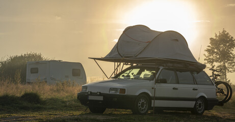 Classic 1980s station wagon fitted with roof tent and expedition gear