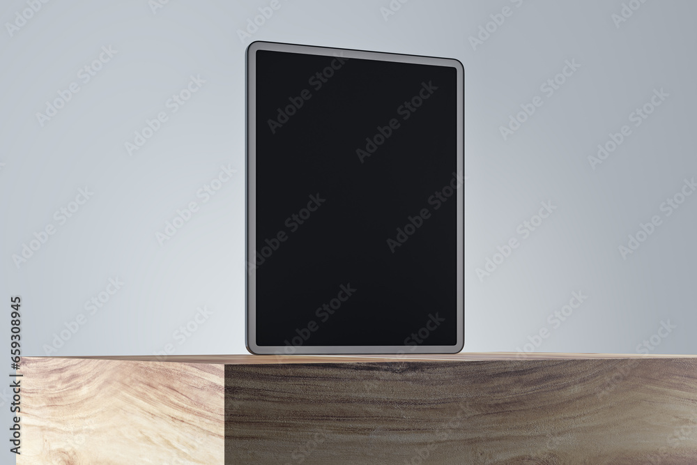 Poster close up of empty tablet screen on wooden surface and gray wall background. product presentation and