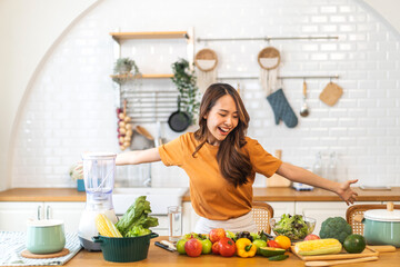 Portrait of beauty body slim healthy asian woman eating vegan food healthy with fresh vegetable salad in kitchen at home.diet, vegetarian, fruit, wellness, health, green food.Fitness and healthy food