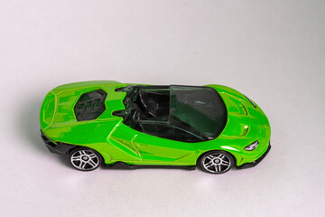 Green toy model convertible supercar on a white background