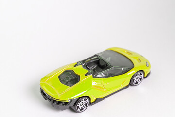 Yellow toy supercar on a white backround