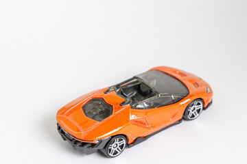 Orange toy supercar on a white backround