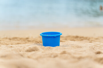 bucket on the beach buried in the sand © Rodrigo