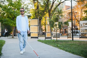 Blind man. Visually impaired man with walking stick,