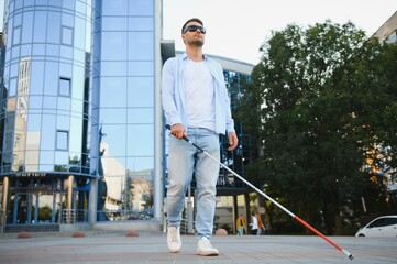 Blind man. Visually impaired man with walking stick,