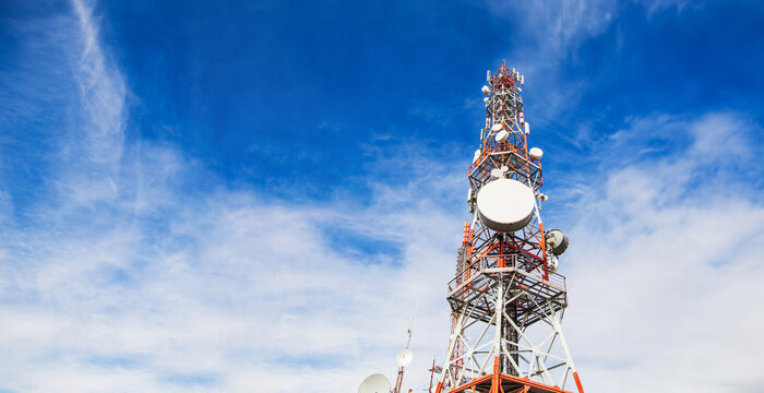 Telecommunication tower. Communication and connection. Wireless antene. Blue sky with clouds in background.