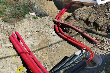 construction workes installing hdpe corrugated pipe with double wall strength at the construction...