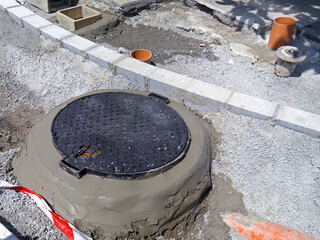 repairing old pipes of the sewage system by construction workers on streets city