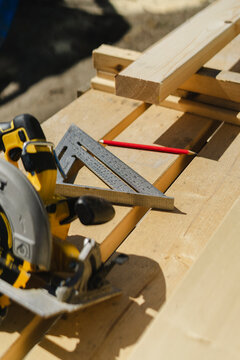 Work Tools And Instrument Of Measurement Near Planks On Sunny Day