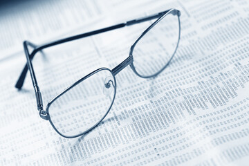 Close up of eye glasses on a business document.