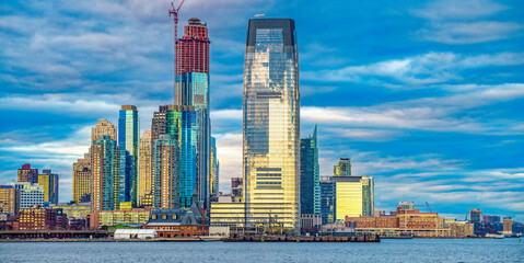 Sunset view of Jersey City skyscrapers from Hudson River