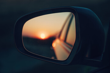 Sunset sky seen in the car's wing mirror - obrazy, fototapety, plakaty