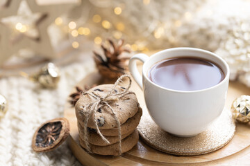 Winter composition with a cup of cocoa and marshmallows on a blurred background.