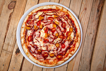 tasty pizza on the wooden background