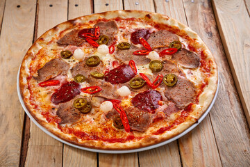 tasty pizza on the wooden background