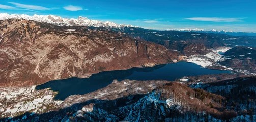 Tuinposter Aerial shot of glacial lake Bohinj in slovenian national park Triglav in winter, seen from the mountain Vogel © Bits and Splits