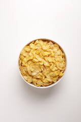 corn flakes in round white plate on white background taken from above