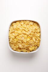 corn flakes in a square plate on a white background taken from above