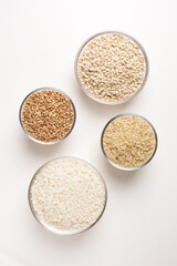 cereals in a group in glass bowls on a white background taken from above