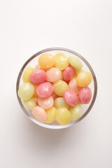 candies in glass bowl on white background shot from above