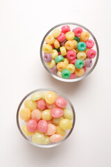 candies in glass bowl on white background shot from above