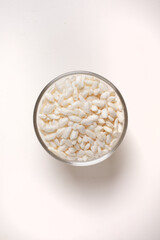 puffed rice in glass bowl on white background taken from above