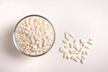 puffed rice in glass bowl on white background taken from above