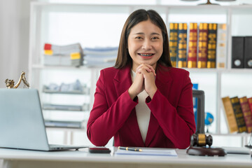 Asian female judge Asian lawyer, judge, lawyer working with legal documents Advice and concept of justice Prosecutor's Office Goddess of justice with scales and lawyer working