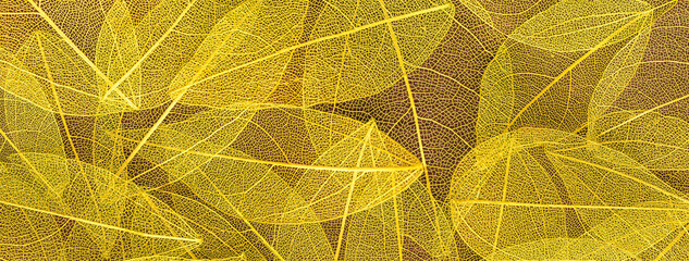 Background from artificial autumn yellow leaves, closeup. Golden leaf texture, nature plant fall...