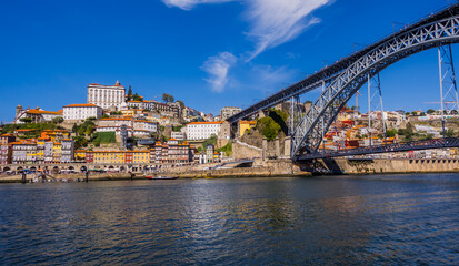 Fototapeta na wymiar Panoramic view of the Douro River with Dom Luis I Bridge in Porto, Portugal
