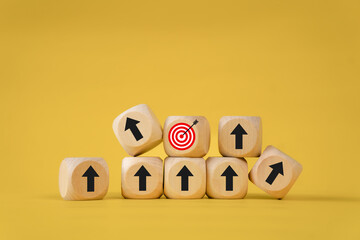 Business growth goals and success goals Scattered wooden blocks with arrow icons and red target icons. Business target or goal success and winner concept.