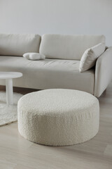 Bouclé pouf in white minimalist design. White sofa