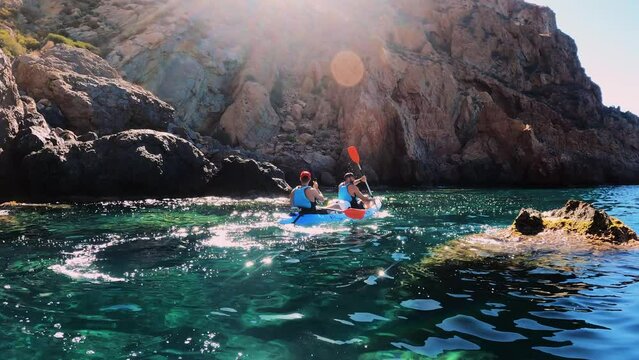 Kayakers rowing at idyllic seascape in Cala cerrada beach at the south of Spain