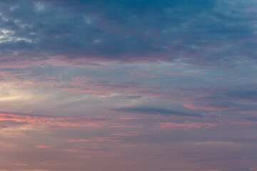 Pink blue clouds at sunset as background