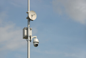 Surveillance system with an orange warning light located on a pole in the open. The threat of...