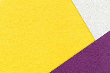 Texture of craft bright yellow color paper background with white and violet border. Vintage...
