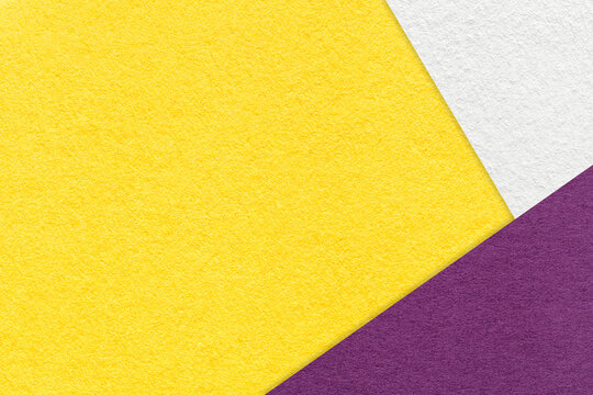Texture of craft bright yellow color paper background with white and violet border. Vintage abstract cardboard.